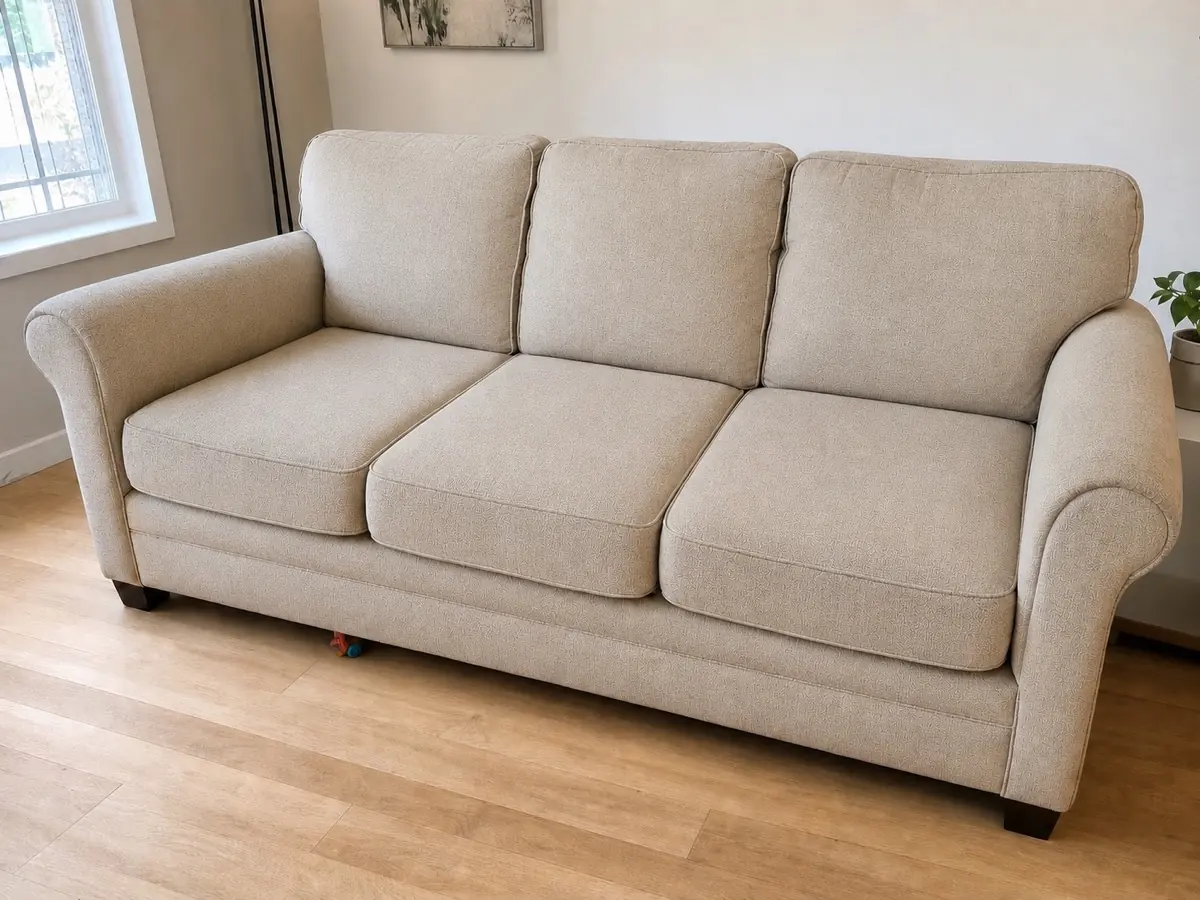 Illustrative neutral fabric sofa used to explain upholstery restoration
